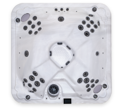 Above view of a white, square-shaped hot tub with rounded corners. The Clearwater Evergreen Series hot tub has multiple seats arranged around the perimeter, each equipped with numerous jets. The interior is white and features a textured floor and built-in headrests for seated positions.